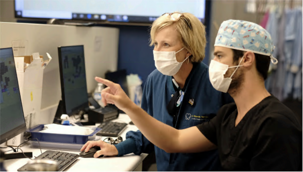 Dental researchers looking at a computer screen.